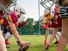 photo of athletes women wearing white helmets playing american football