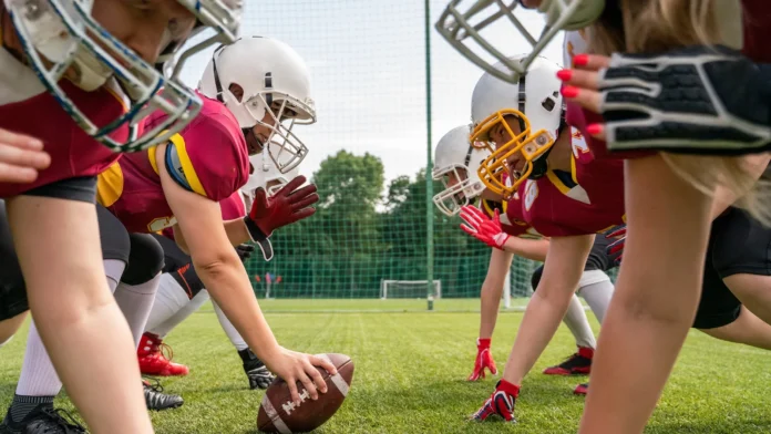 nfl, women playing football, photo of athletes women wearing white helmets playing american football photo of athletes women wearing white helmets playing american football