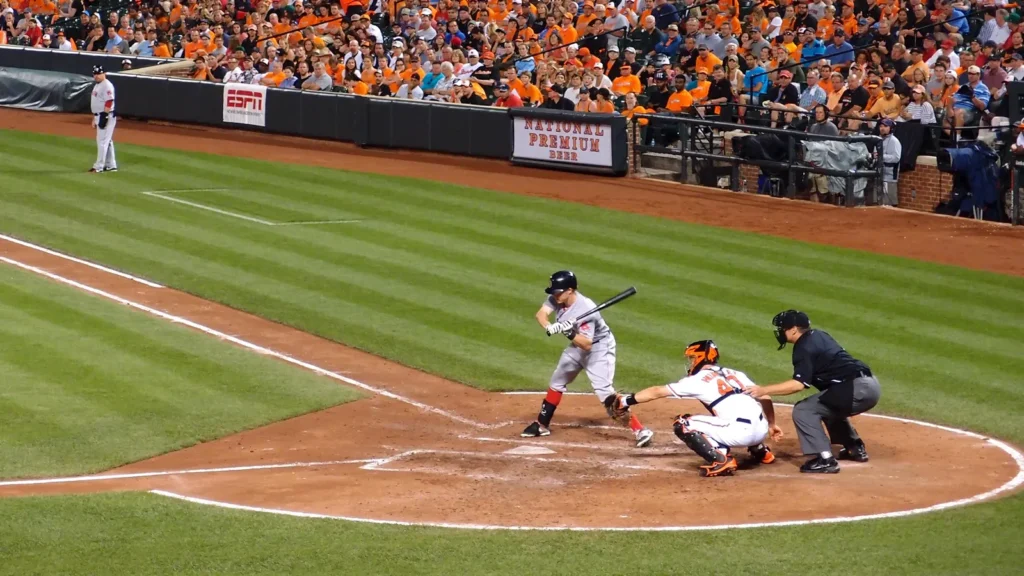 Red Sox player hitting the ball.