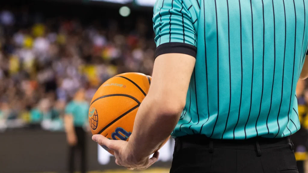 Referee holding a basketball during a game