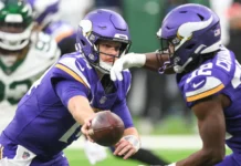 Sam Darnold in action while wearing his former Minnesota Vikings uniform