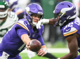 Sam Darnold in action while wearing his former Minnesota Vikings uniform