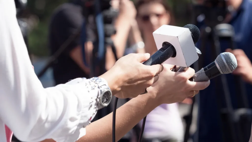 Interviewer with microphone asking questions